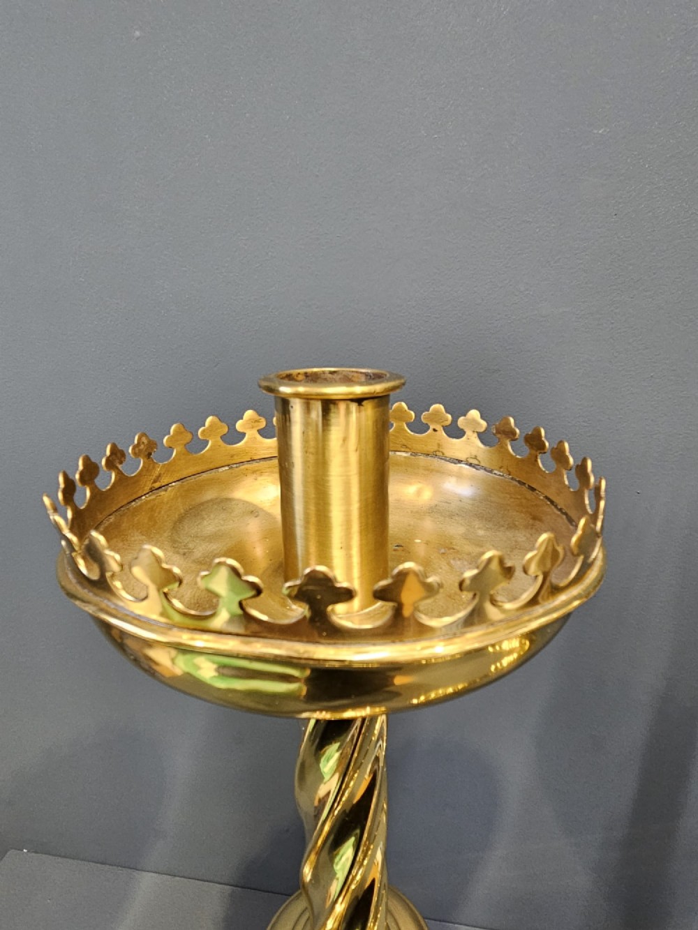 A pair of tall, polished brass Victorian church candlesticks with barley twist stems, crenellated crowns, and circular stepped bases. View V