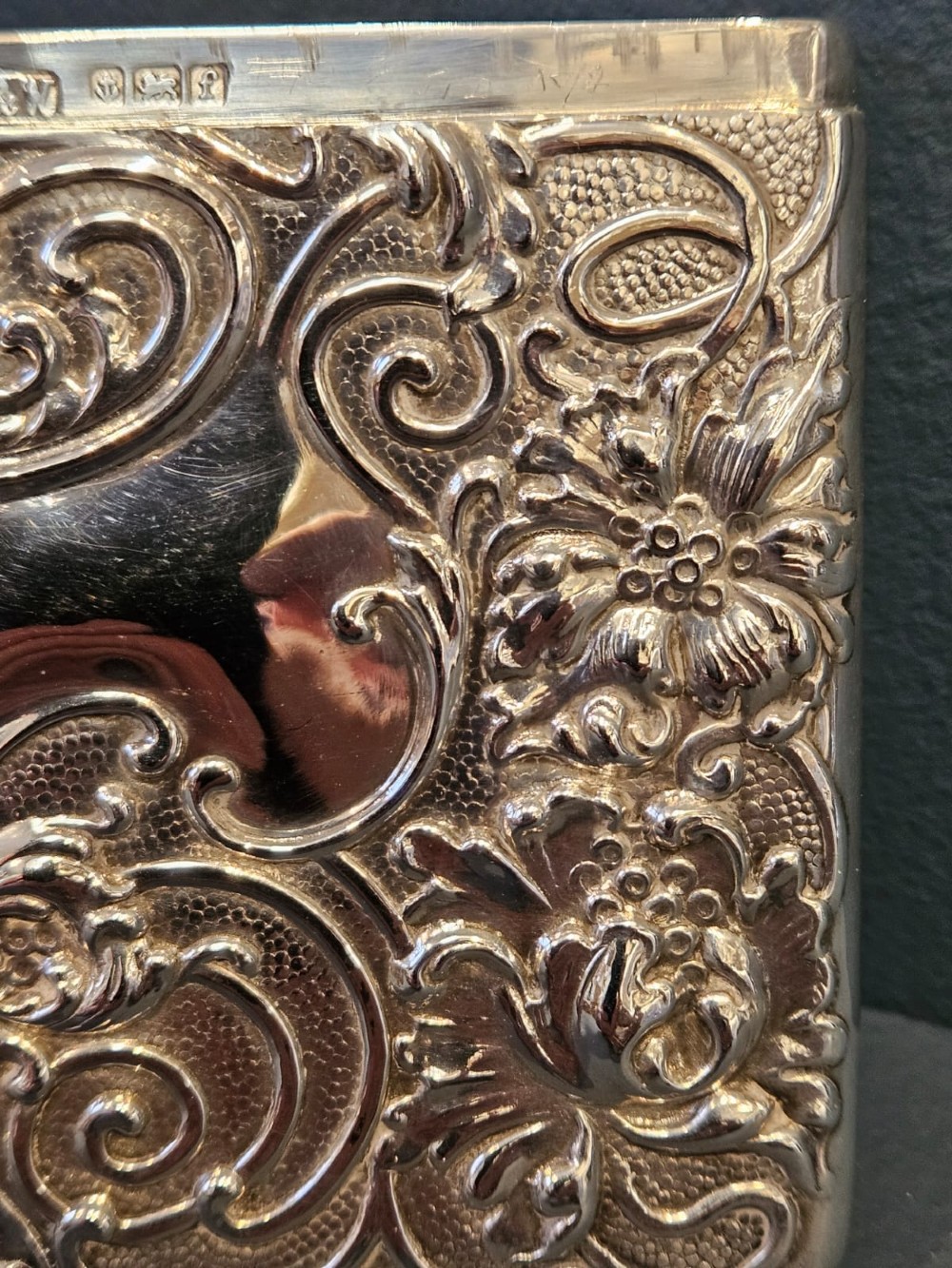 An Edwardian sterling silver hinged card case featuring intricate Art Nouveau repousse scrollwork and floral relief design. View III