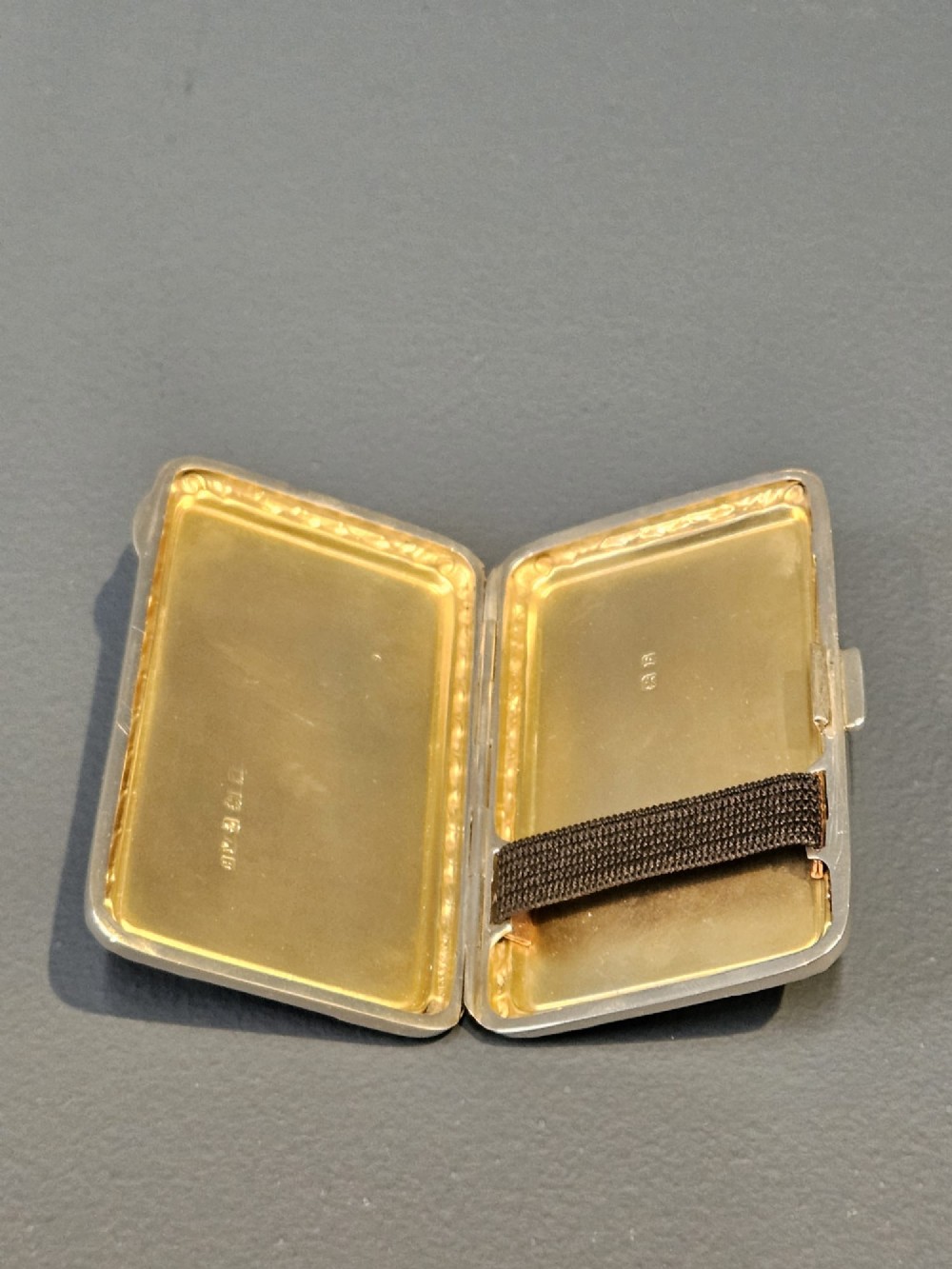A rectangular silver case featuring a sky-blue engine-turned guilloche enamel panel and an ornate chased border. View II