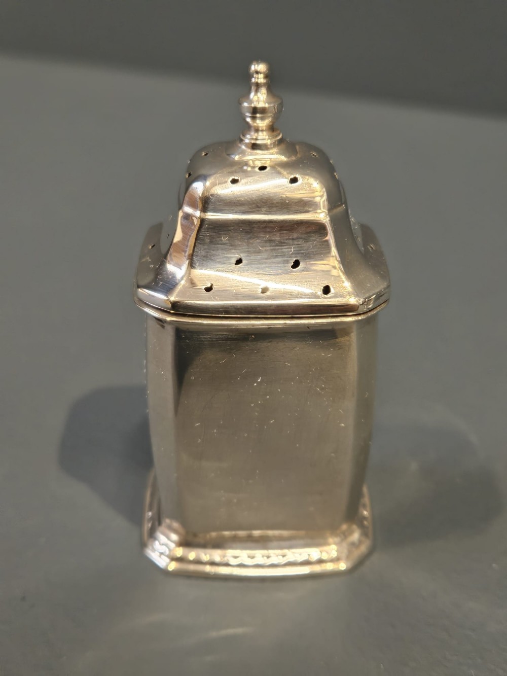 A cased five-piece silver cruet set featuring two pepper casters, two open salt cellars with blue glass liners, a mustard pot, and three spoons inside a silk-lined box. View III