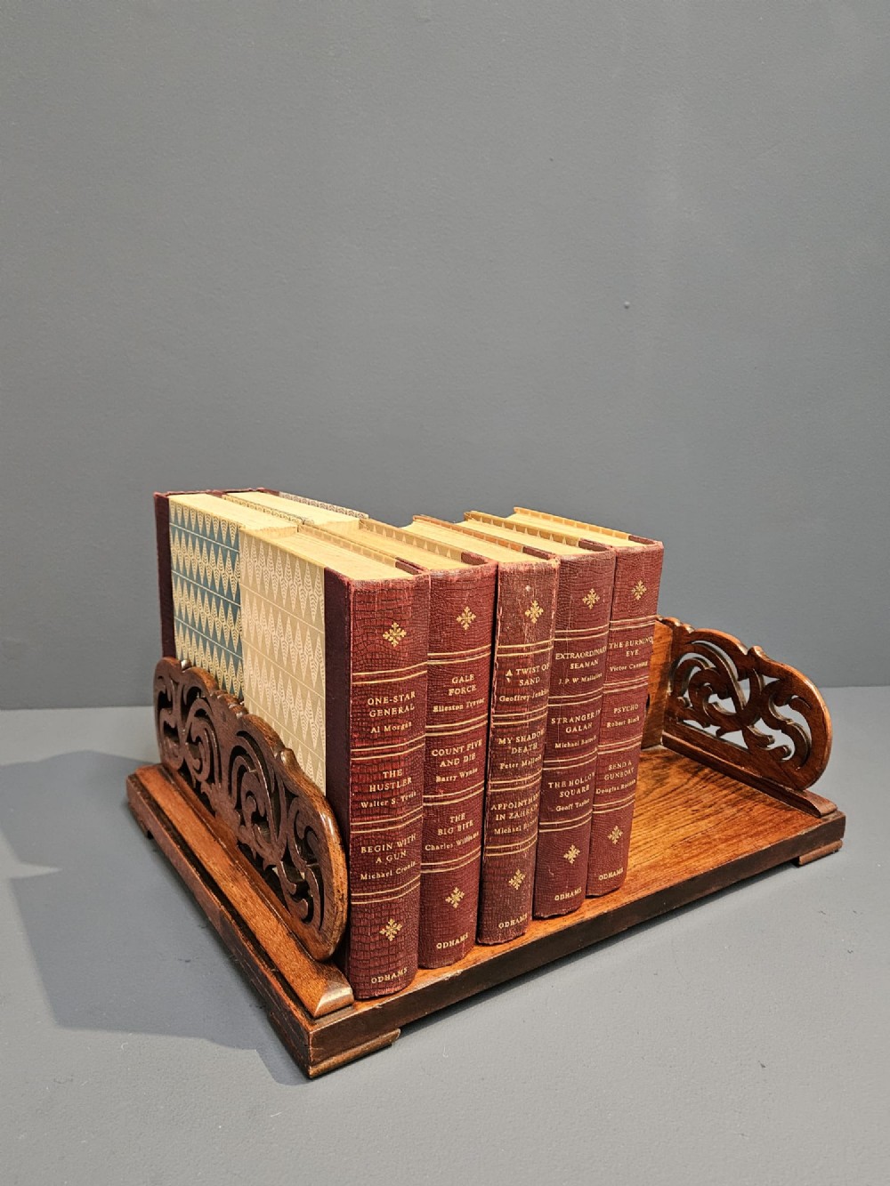 An antique Regency rosewood book carrier featuring openwork scroll-carved galleries and a central top handle. View II