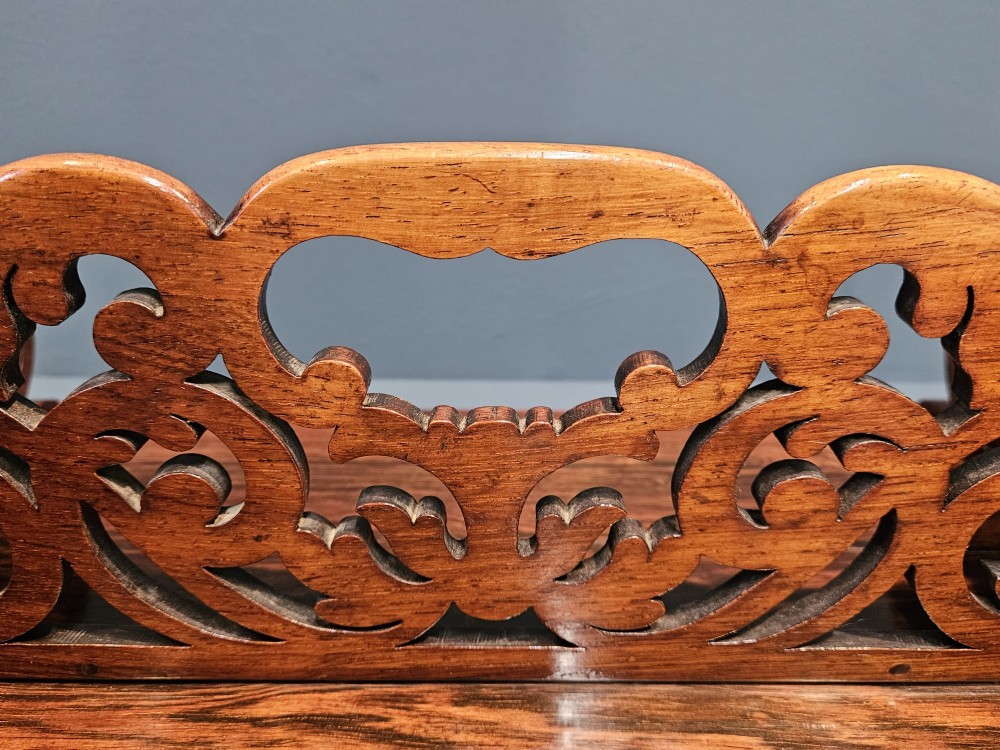 An antique Regency rosewood book carrier featuring openwork scroll-carved galleries and a central top handle. View III