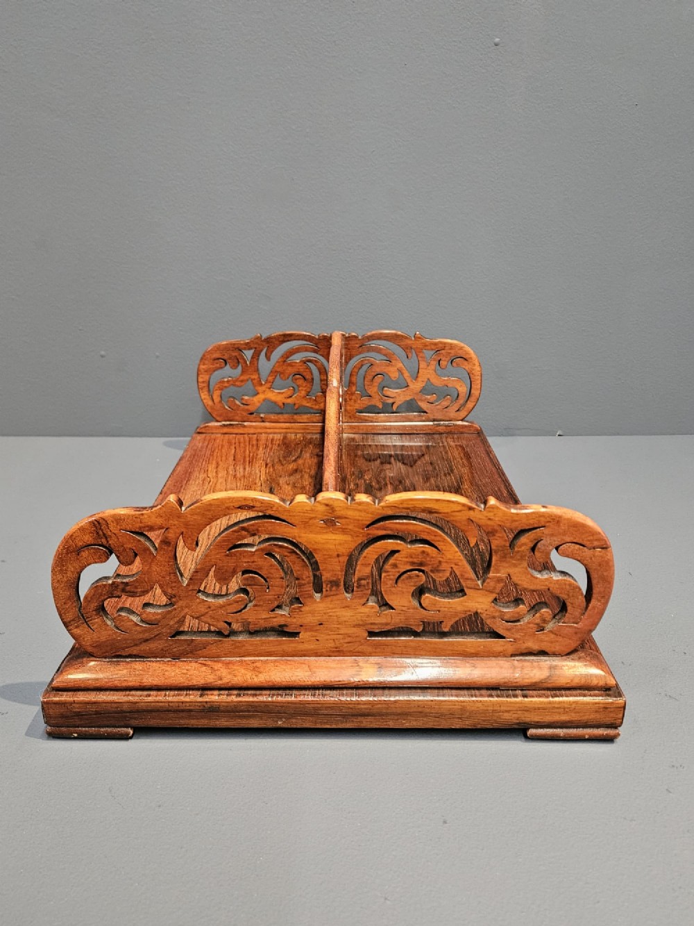 An antique Regency rosewood book carrier featuring openwork scroll-carved galleries and a central top handle. View VI