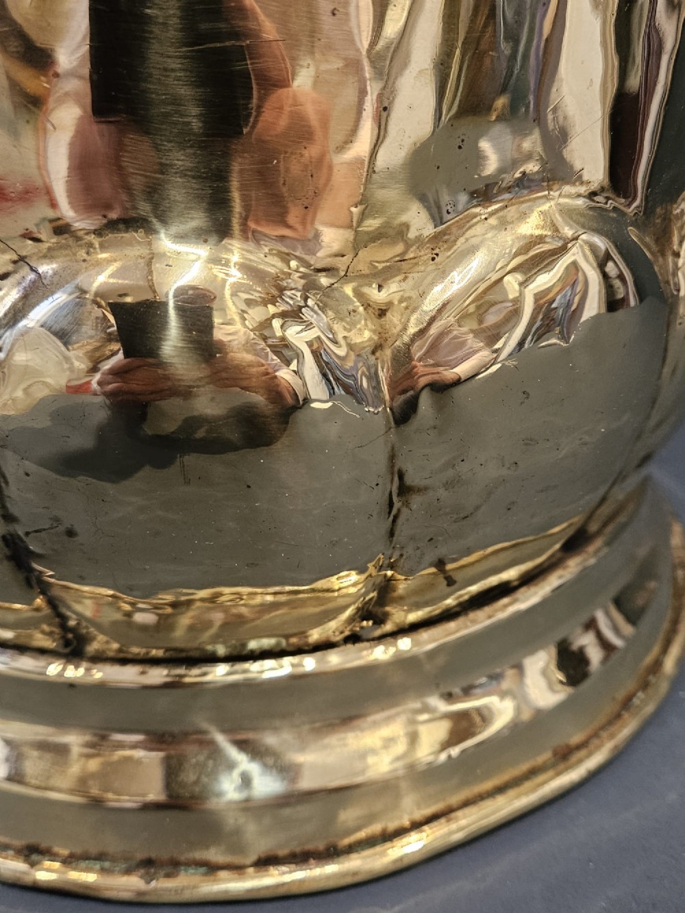 A Victorian brass planter featuring a polished finish, lobed lower body, and cast lion mask ring handles. View V