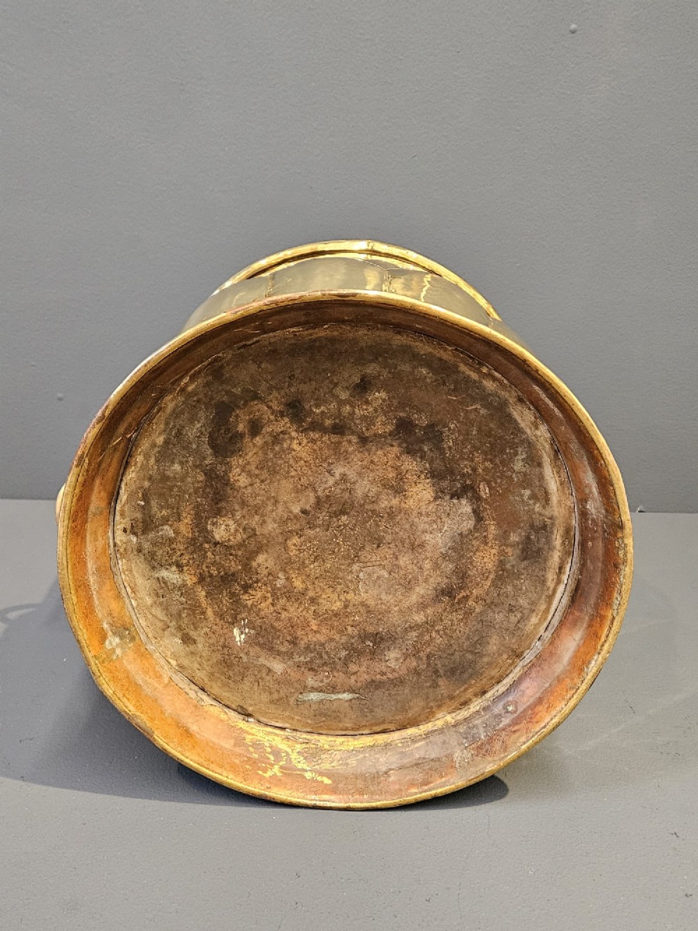 A Victorian brass planter featuring a polished finish, lobed lower body, and cast lion mask ring handles. View VII