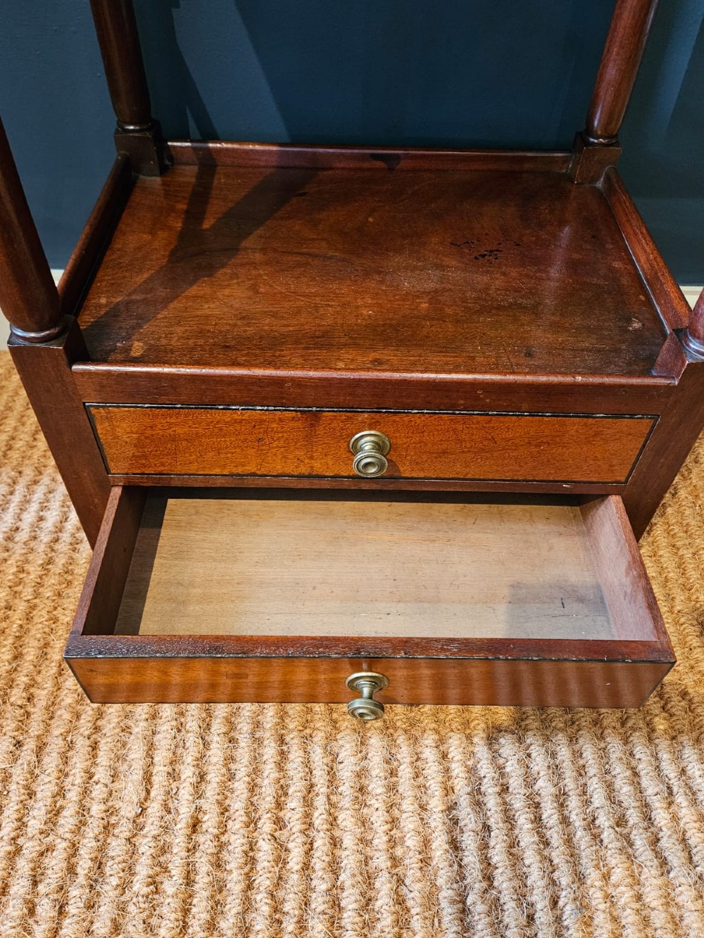 A tall Regency four-tier mahogany whatnot stand with slender turned posts, finial top ornaments, open shelves, and a base drawer. View II