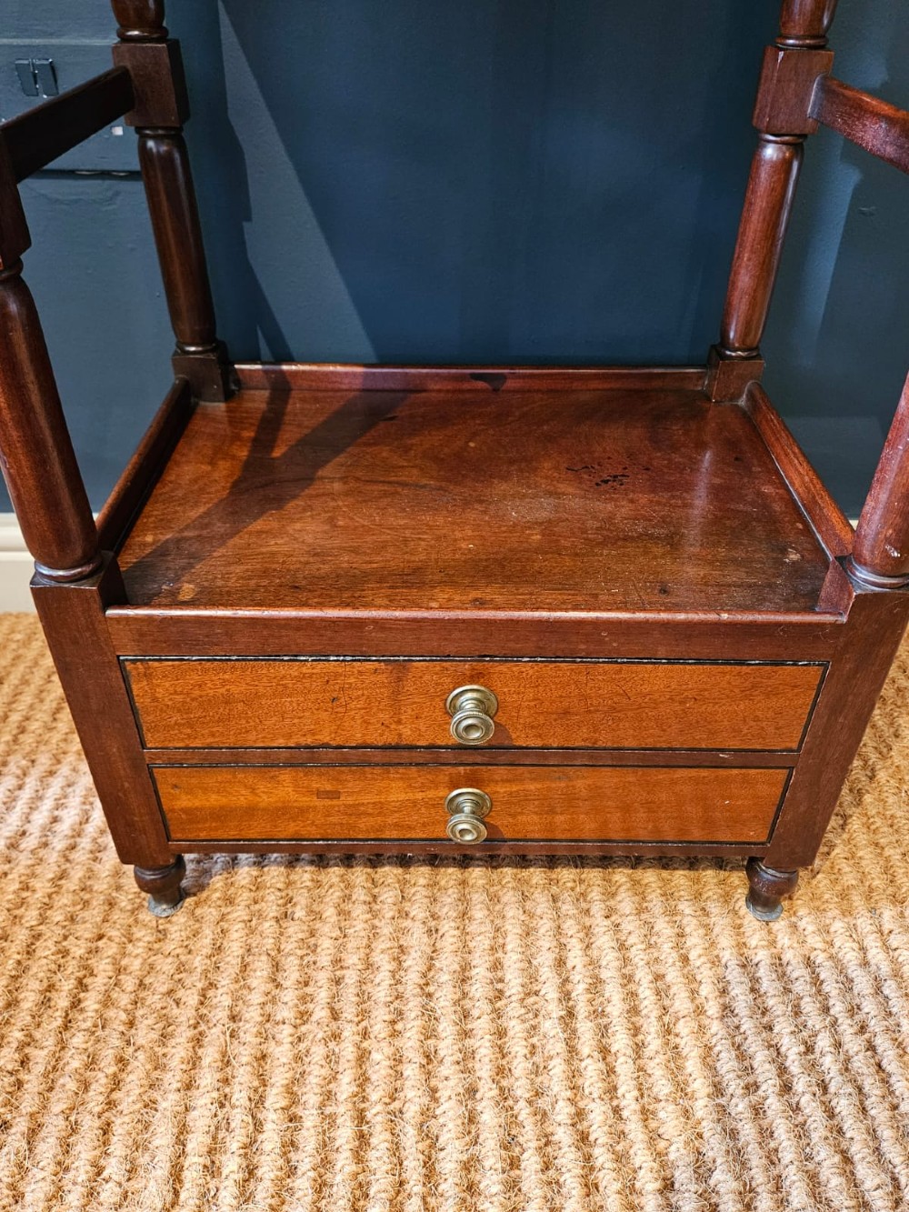 A tall Regency four-tier mahogany whatnot stand with slender turned posts, finial top ornaments, open shelves, and a base drawer. View IV