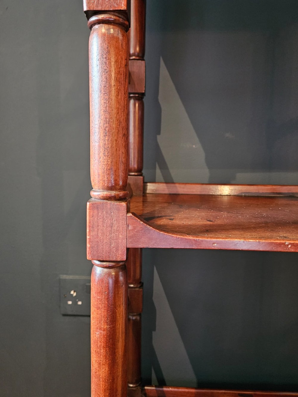 A tall Regency four-tier mahogany whatnot stand with slender turned posts, finial top ornaments, open shelves, and a base drawer. View V