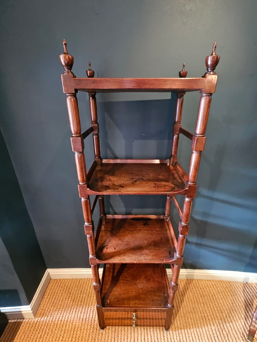 A tall Regency four-tier mahogany whatnot stand with slender turned posts, finial top ornaments, open shelves, and a base drawer. View VI