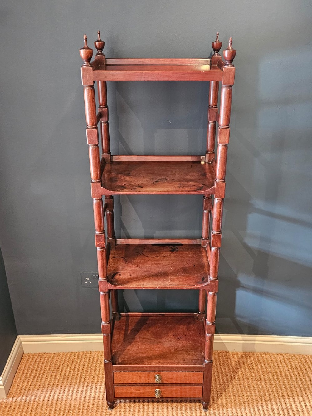 A tall Regency four-tier mahogany whatnot stand with slender turned posts, finial top ornaments, open shelves, and a base drawer. View VII