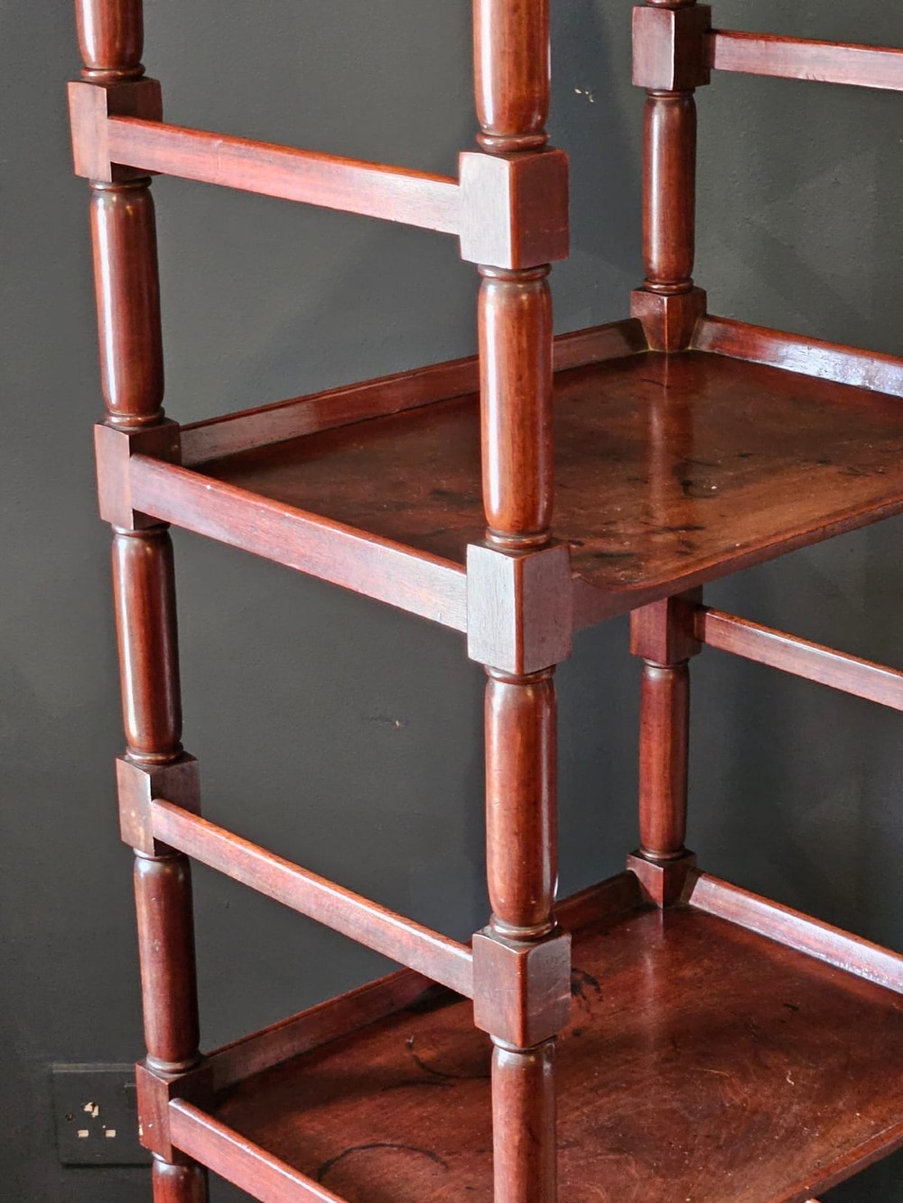 A tall Regency four-tier mahogany whatnot stand with slender turned posts, finial top ornaments, open shelves, and a base drawer. View VIII
