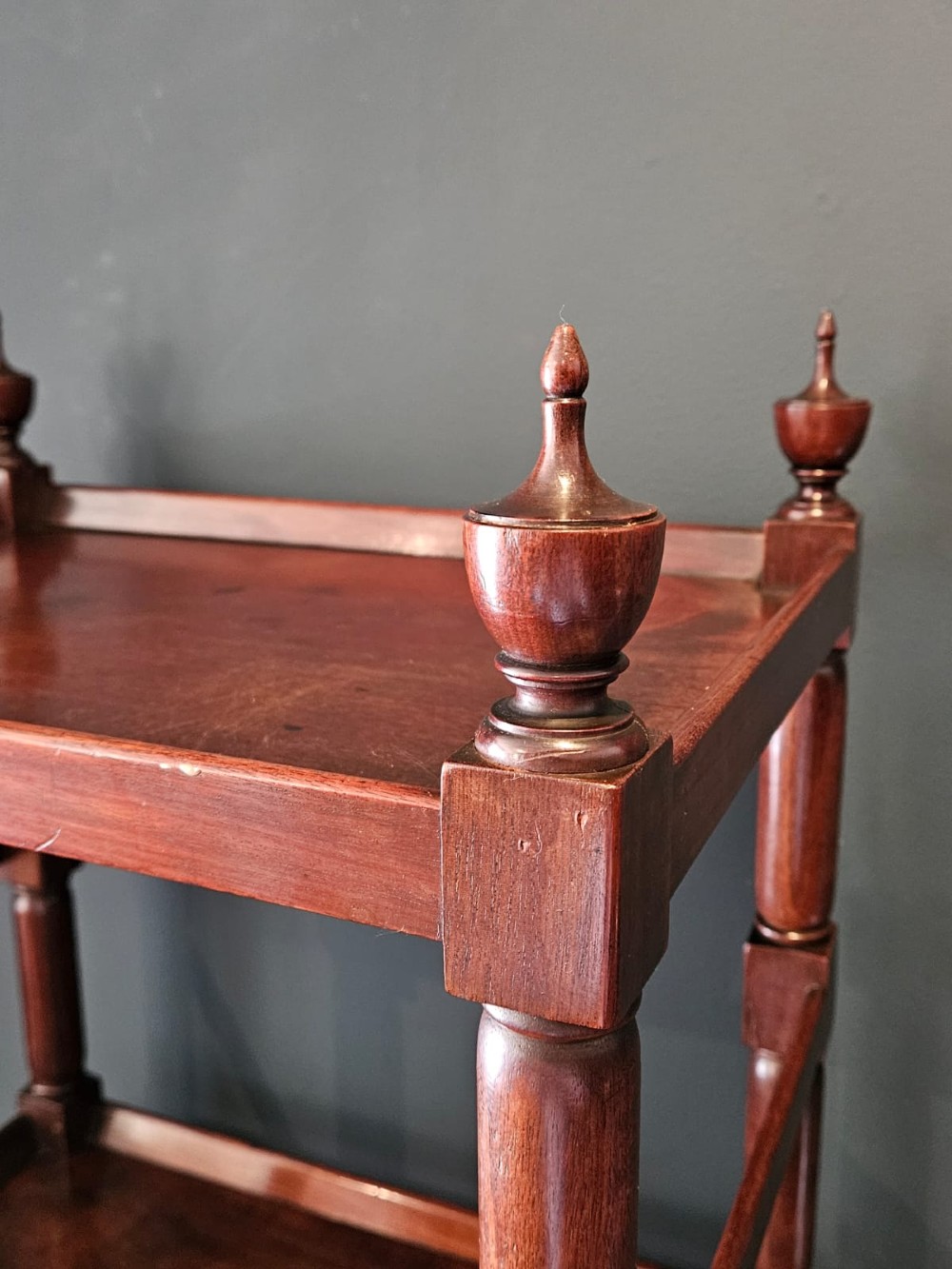 A tall Regency four-tier mahogany whatnot stand with slender turned posts, finial top ornaments, open shelves, and a base drawer. View X