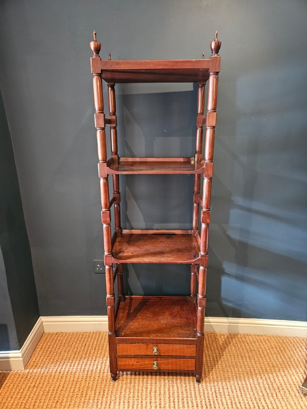 A tall Regency four-tier mahogany whatnot stand with slender turned posts, finial top ornaments, open shelves, and a base drawer. View XI