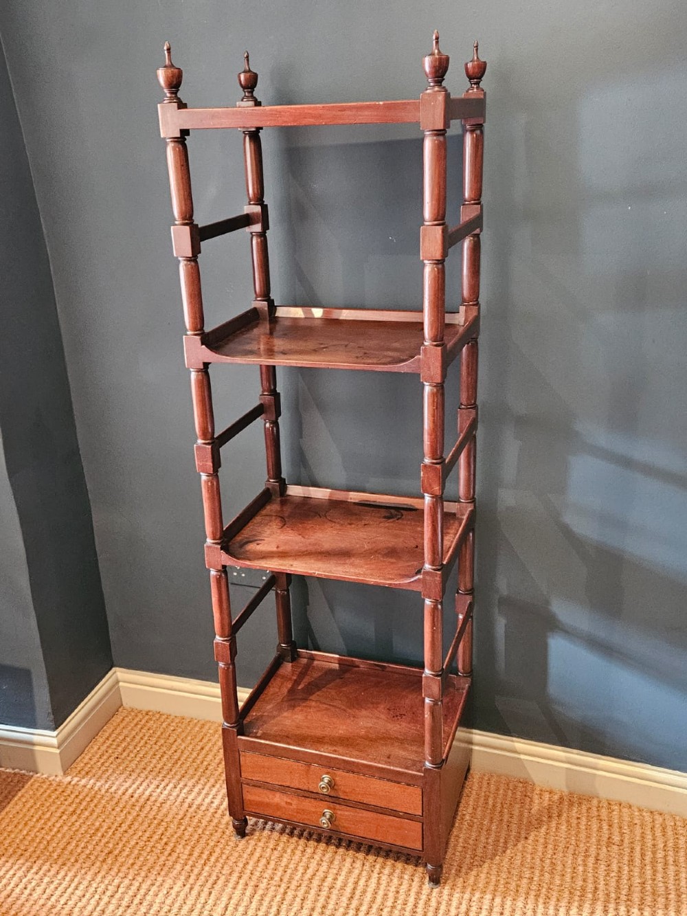A tall Regency four-tier mahogany whatnot stand with slender turned posts, finial top ornaments, open shelves, and a base drawer. View XII