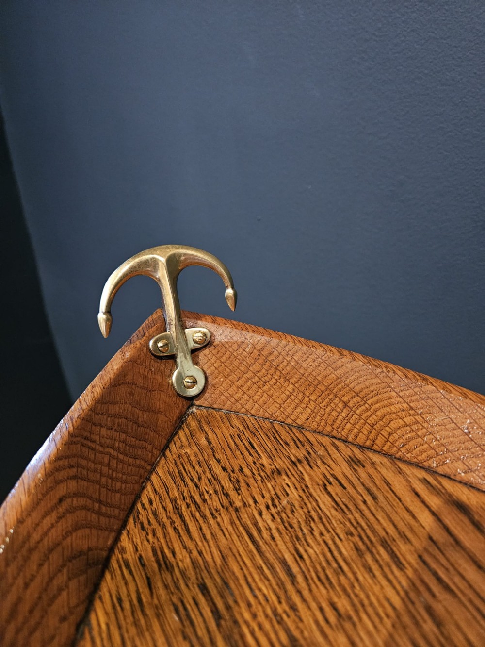 A boat-shaped oak tray with brass handles resting on a folding wooden stand constructed from crossed oars. View VI