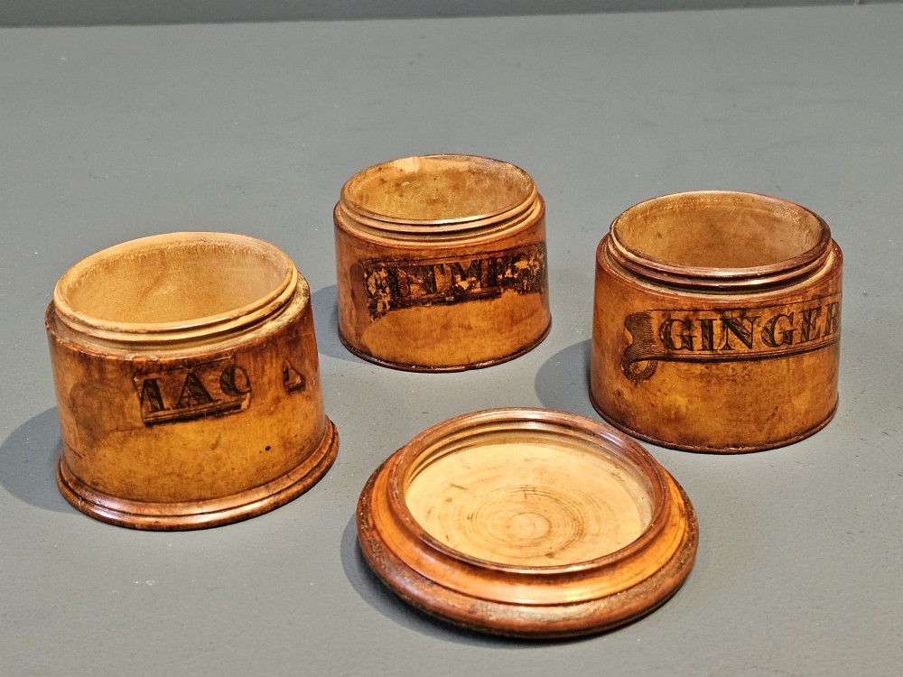 A cylindrical turned fruitwood spice tower featuring stacked compartments labelled Nutmeg, Ginger, and Mace. View VI