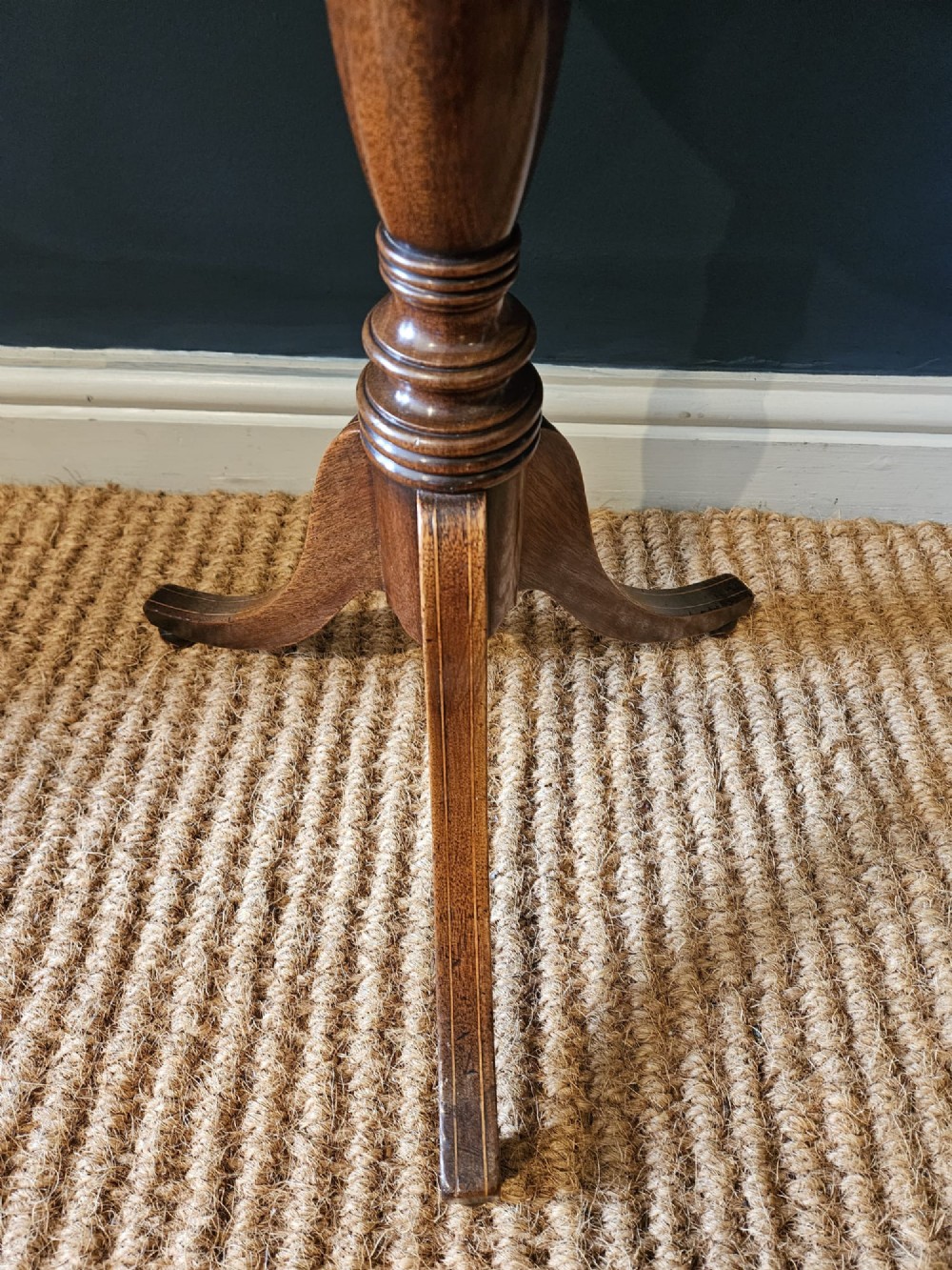 A George III mahogany wine table featuring a dished circular top, a turned central column, and a tripod base with three splayed legs. View III