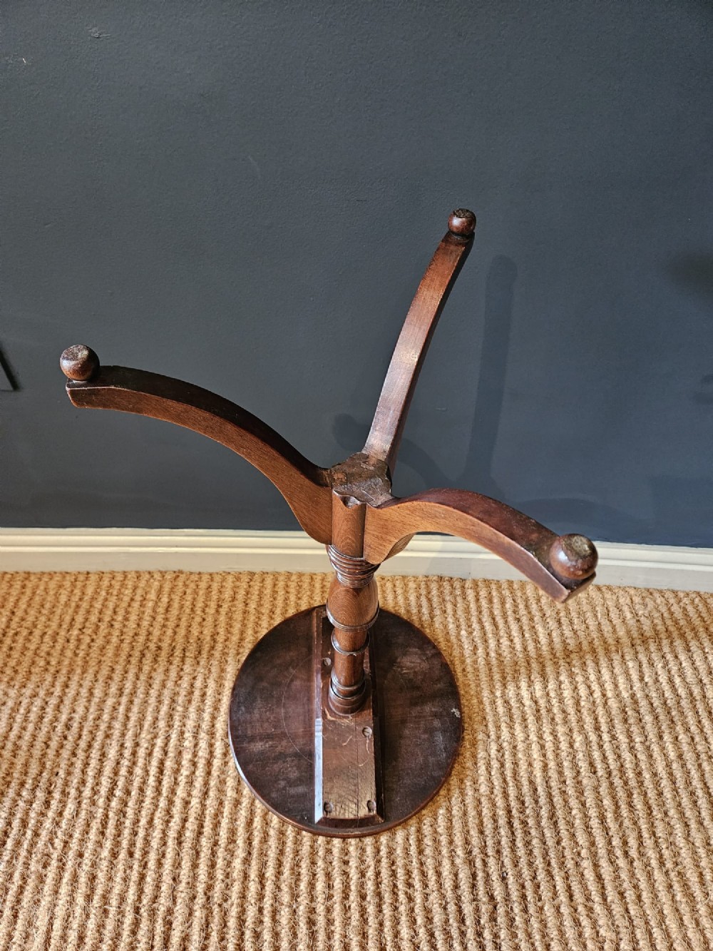 A George III mahogany wine table featuring a dished circular top, a turned central column, and a tripod base with three splayed legs. View VI