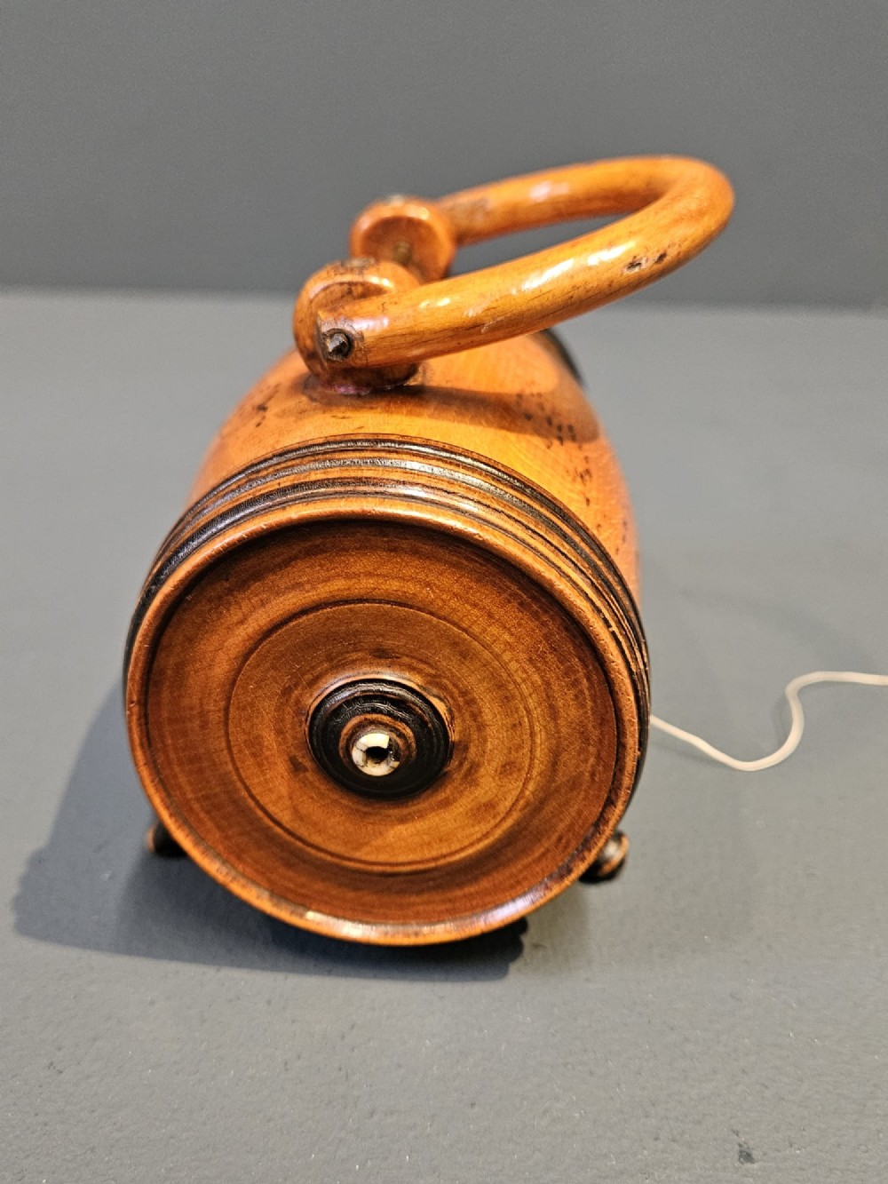 A turned Victorian fruitwood string barrel resting on four short turned feet with an arched top handle and dark ring details. View IV