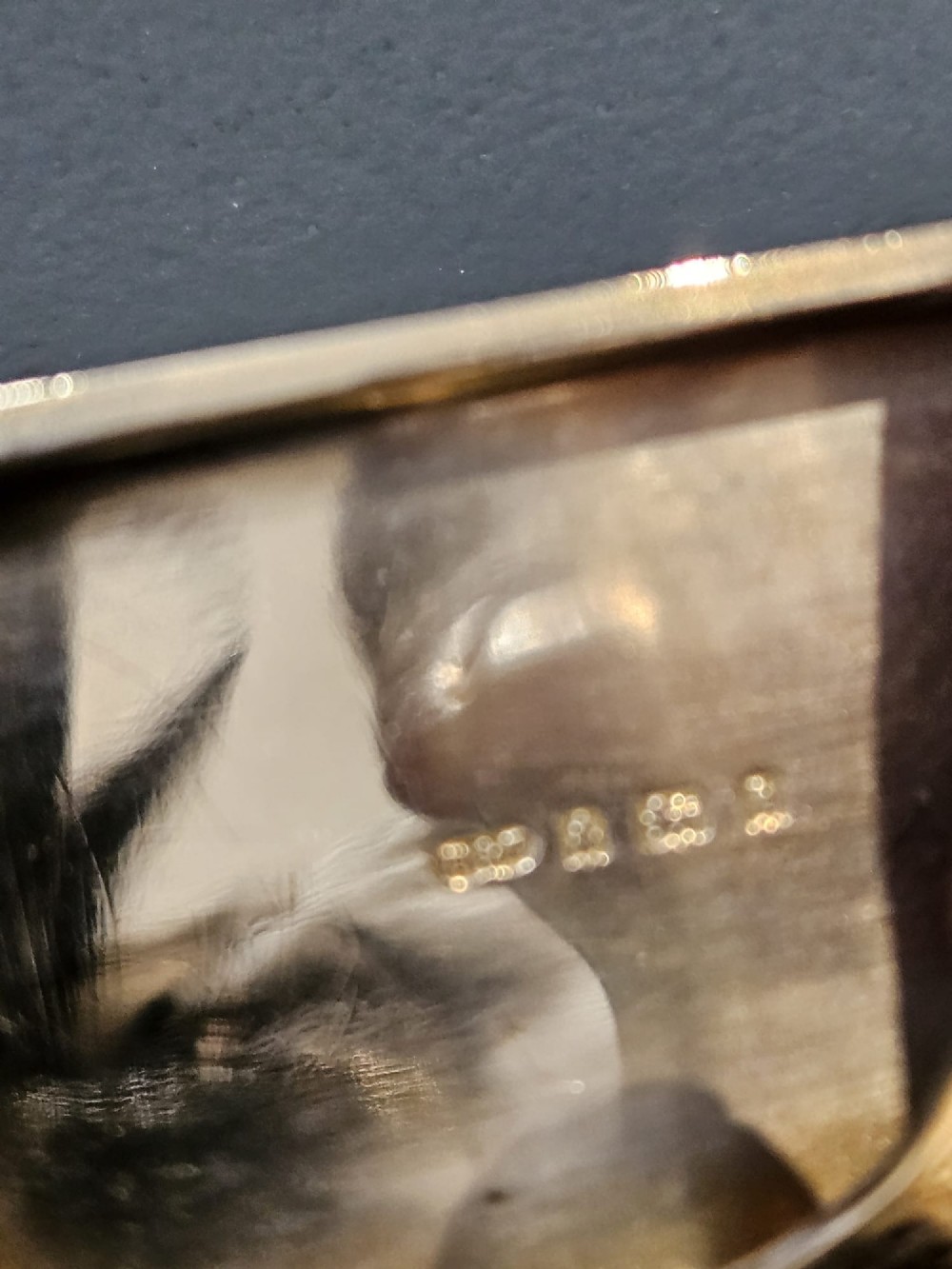 A rectangular polished sterling silver double sovereign and banknote case featuring a top suspension ring and side push-button catch. View II