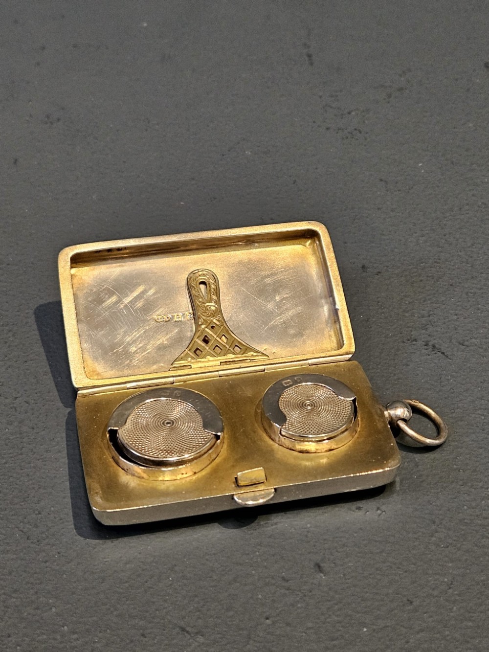 A rectangular polished sterling silver double sovereign and banknote case featuring a top suspension ring and side push-button catch. View III