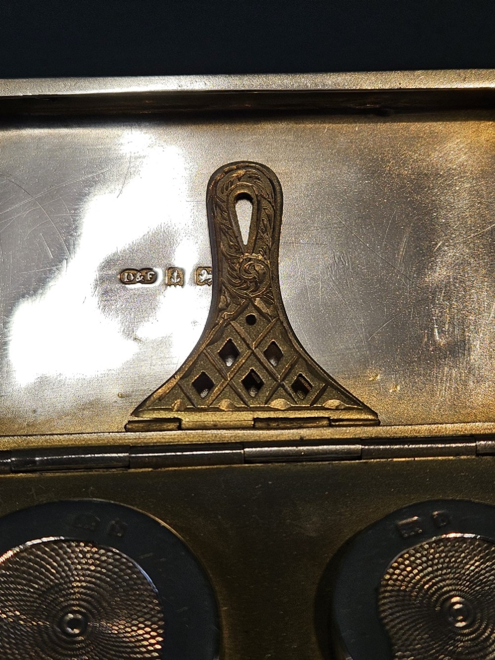 A rectangular polished sterling silver double sovereign and banknote case featuring a top suspension ring and side push-button catch. View VII