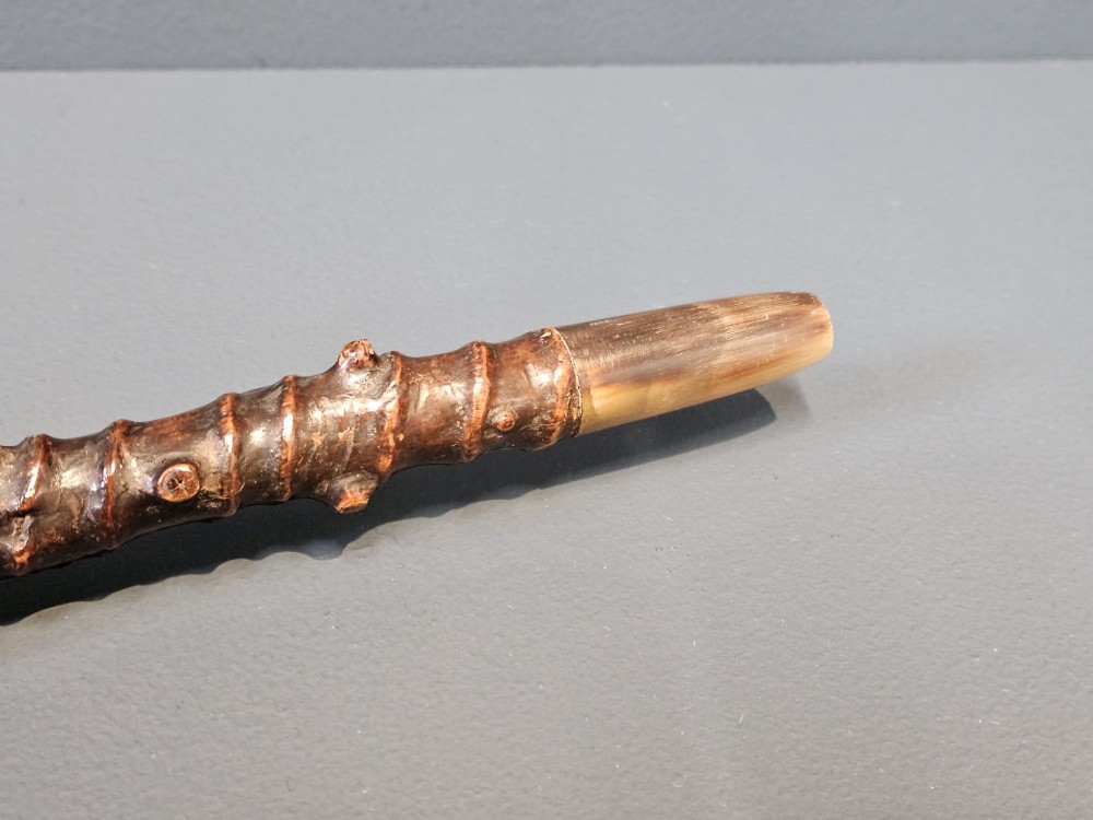 An Edwardian walking stick with a hand-carved wooden dog head handle on a knobbly blackthorn shaft with a silver-coloured collar. View IV