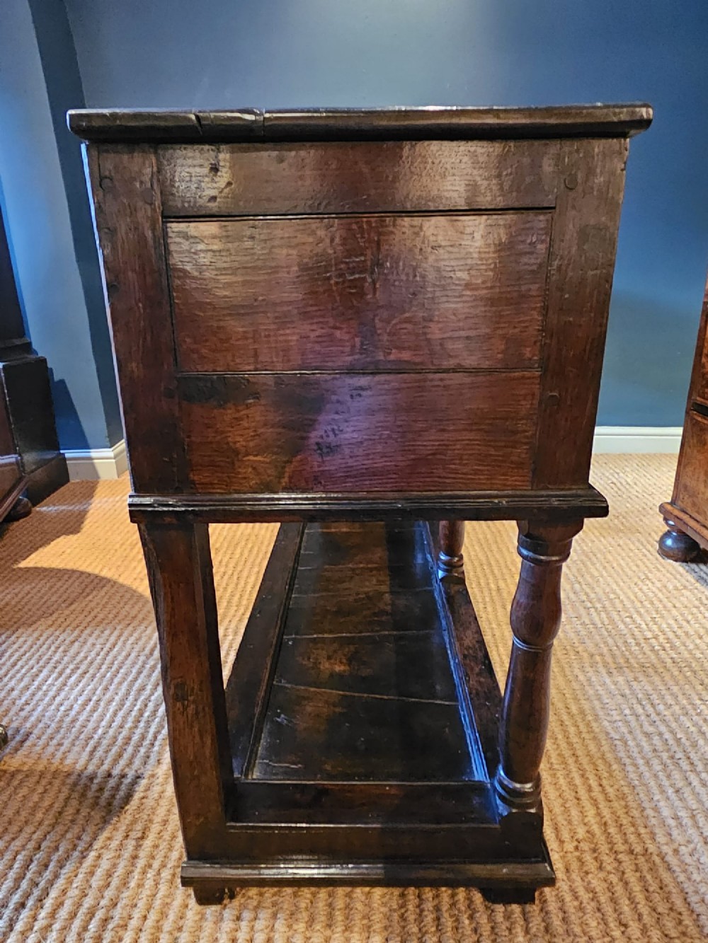 An 18th-century George II oak pot board dresser featuring three frieze drawers with brass handles set above an open lower shelf and turned baluster supports. View II