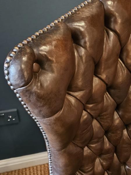A Victorian dark brown leather armchair featuring deep button tufting, brass stud trimming, and cabriole front legs. View II
