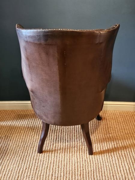 A Victorian dark brown leather armchair featuring deep button tufting, brass stud trimming, and cabriole front legs. View IV