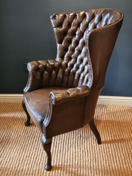 A Victorian dark brown leather armchair featuring deep button tufting, brass stud trimming, and cabriole front legs. View V