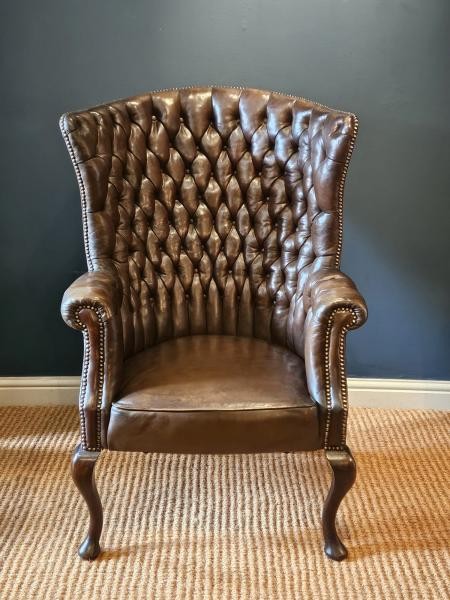 A Victorian dark brown leather armchair featuring deep button tufting, brass stud trimming, and cabriole front legs. View VII