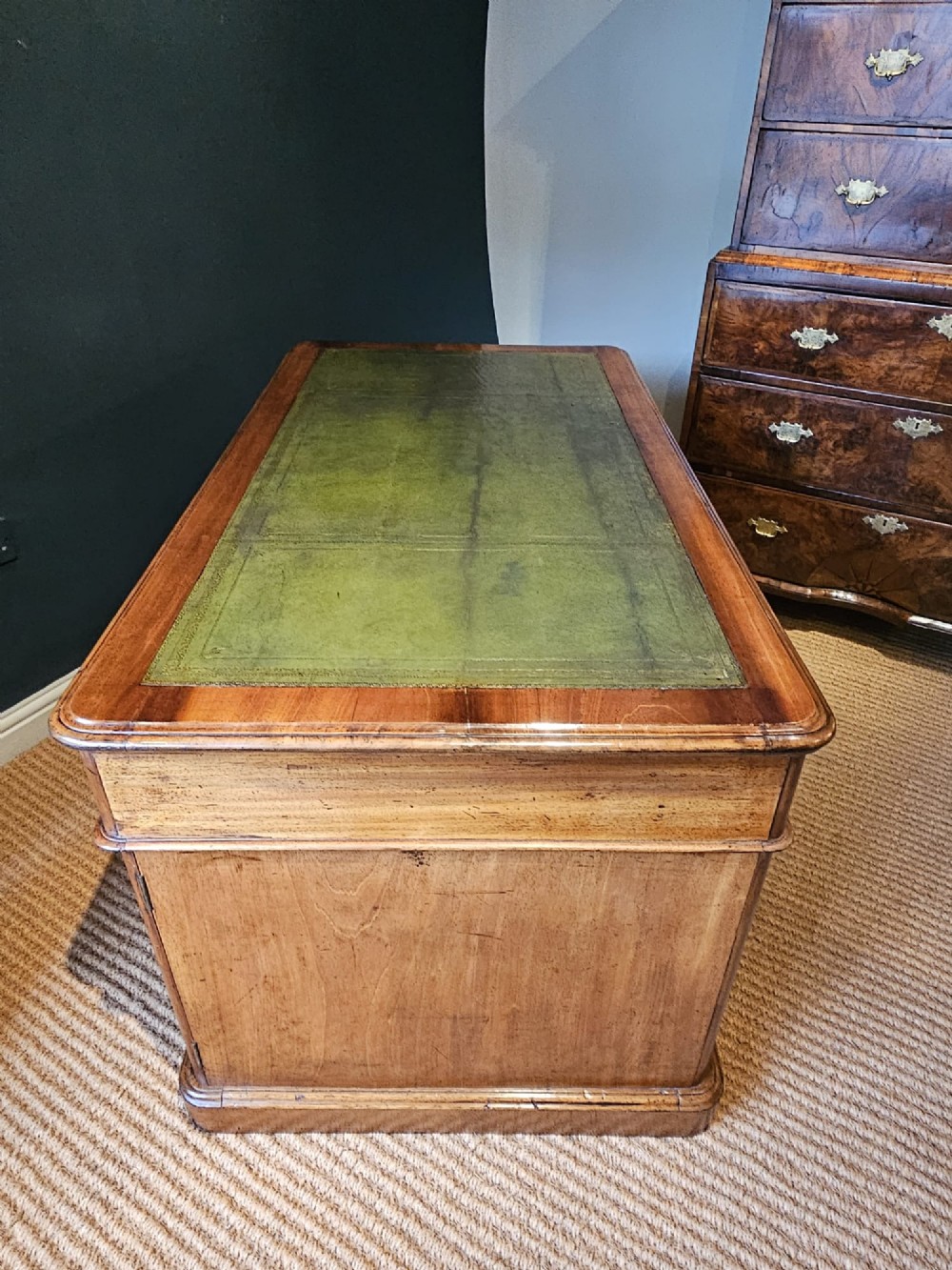 A Mid-Victorian mahogany partners desk featuring a pedestal layout with nine drawers on the front, turned timber knobs, and a solid plinth base. View VII