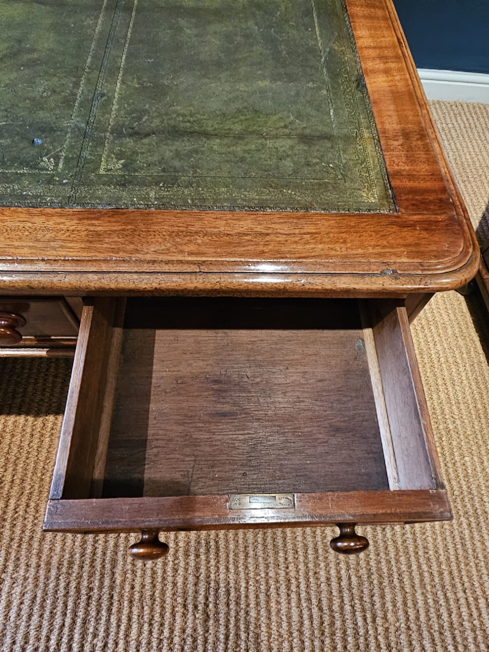 A Mid-Victorian mahogany partners desk featuring a pedestal layout with nine drawers on the front, turned timber knobs, and a solid plinth base. View X