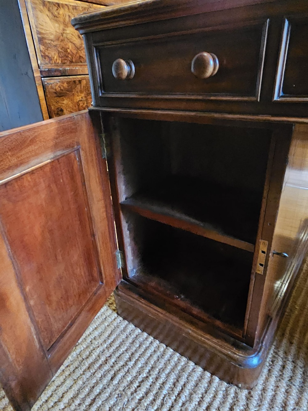 A Mid-Victorian mahogany partners desk featuring a pedestal layout with nine drawers on the front, turned timber knobs, and a solid plinth base. View XI