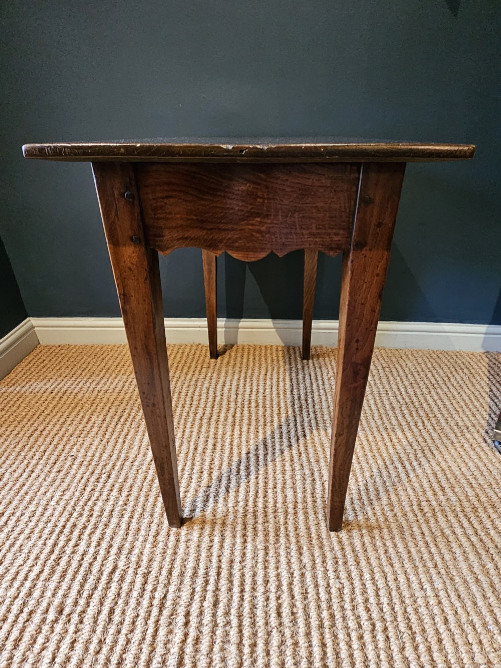 A George III elm single drawer side table featuring a rectangular top, a shaped apron, a turned wooden drawer knob, and tapered square legs. View VII