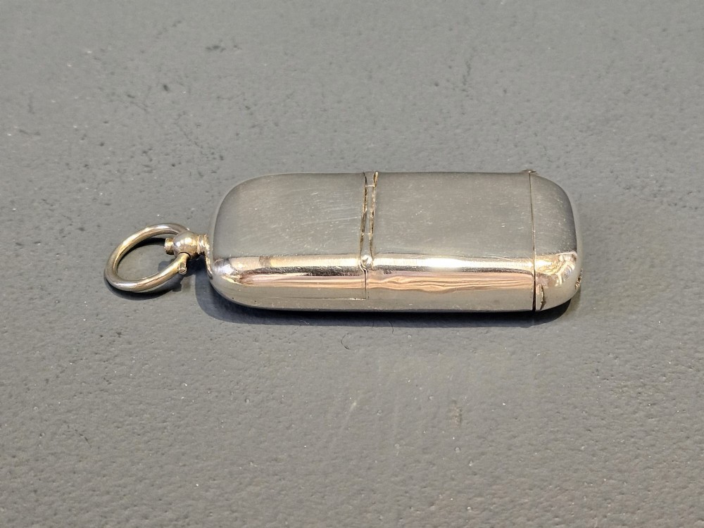 A smooth polished George V silver combination case featuring separate compartments and a top suspension ring.