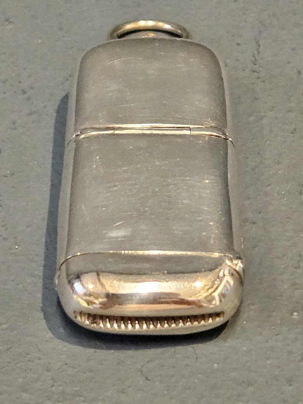 A smooth polished George V silver combination case featuring separate compartments and a top suspension ring. View II