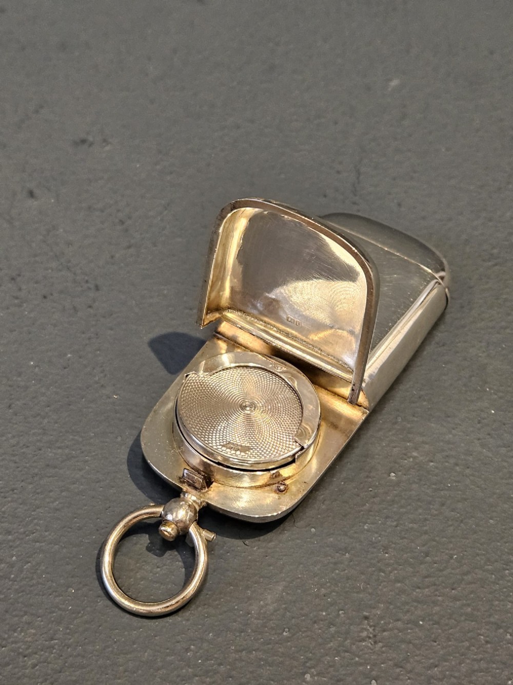 A smooth polished George V silver combination case featuring separate compartments and a top suspension ring. View III