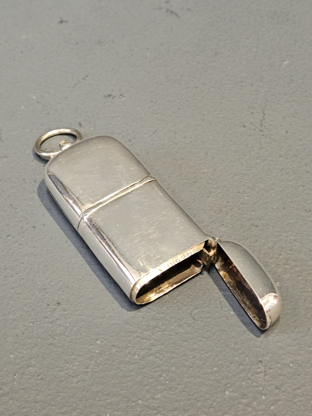 A smooth polished George V silver combination case featuring separate compartments and a top suspension ring. View IV