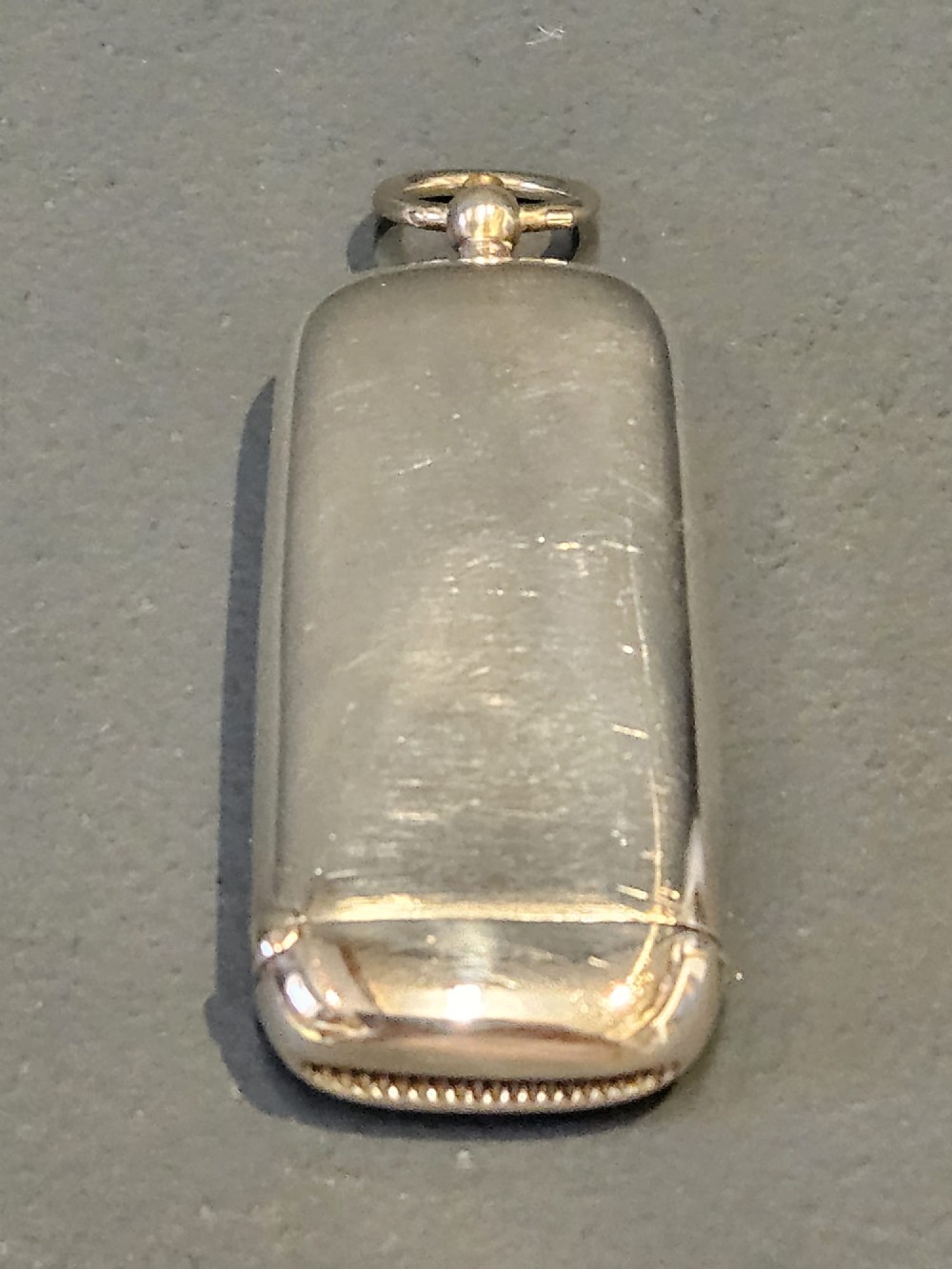 A smooth polished George V silver combination case featuring separate compartments and a top suspension ring. View V
