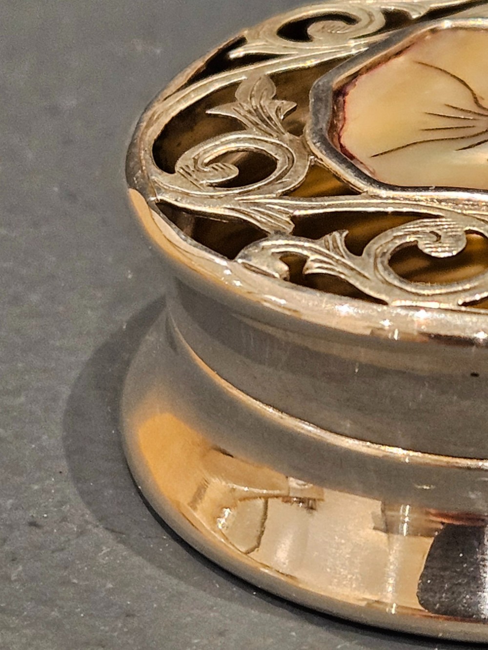 A circular Edwardian silver pot-pourri box featuring a pierced scrollwork lid set with a central mother-of-pearl floral inset. View II