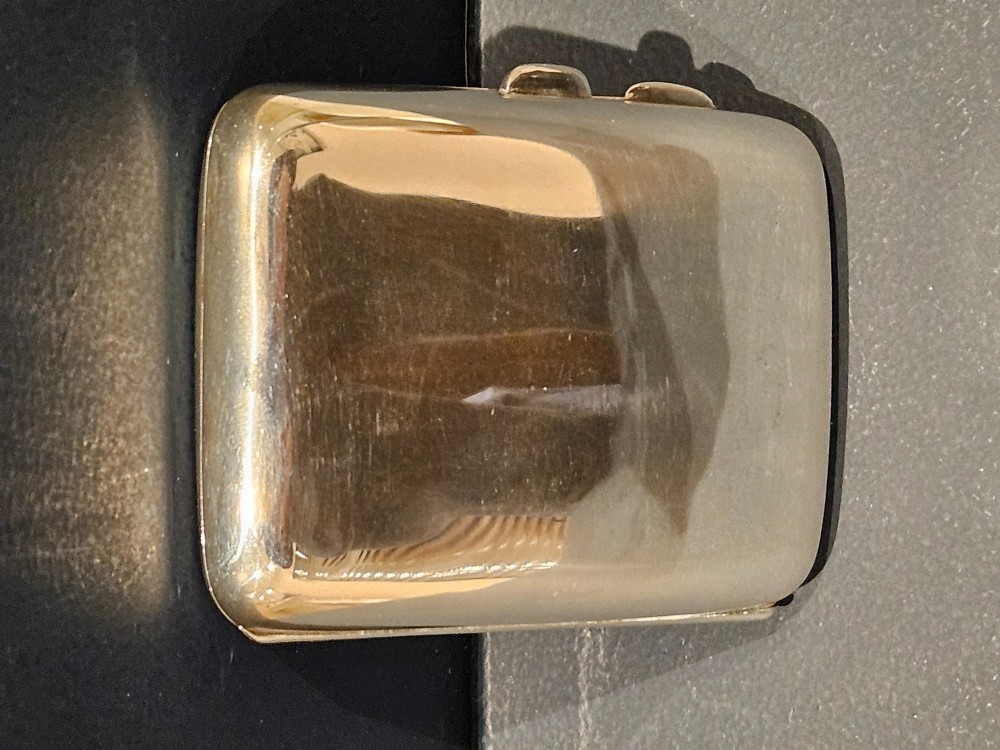 A rectangular engraved sterling silver cheroot case featuring floral motifs and an integrated circular hinged compact lid. View II
