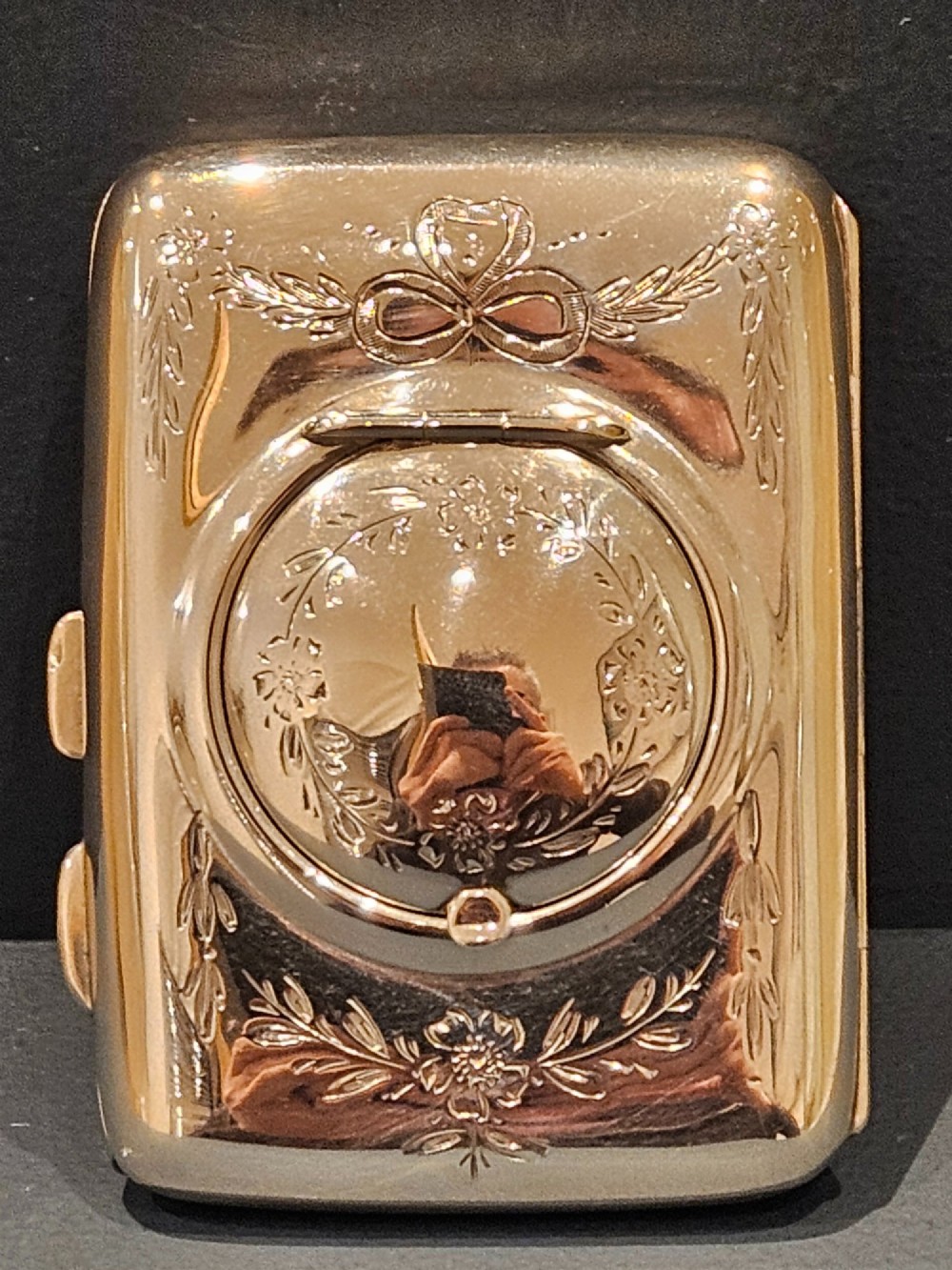 A rectangular engraved sterling silver cheroot case featuring floral motifs and an integrated circular hinged compact lid. View IV