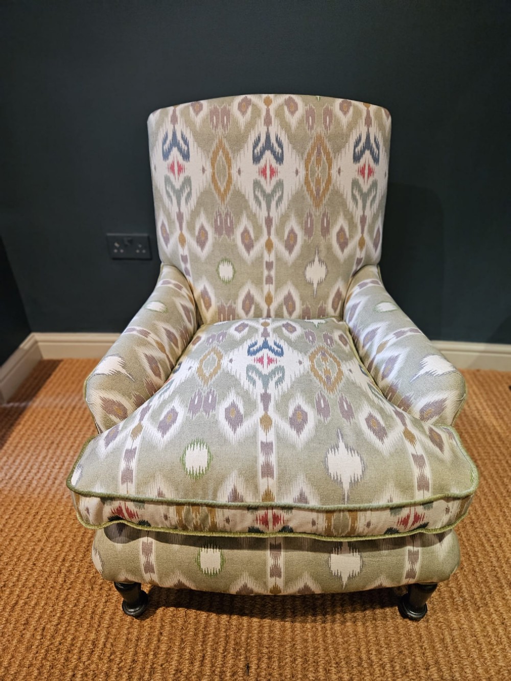 A pair of Victorian armchairs reupholstered in a geometric sage green ikat linen fabric with turned dark timber front legs. View II