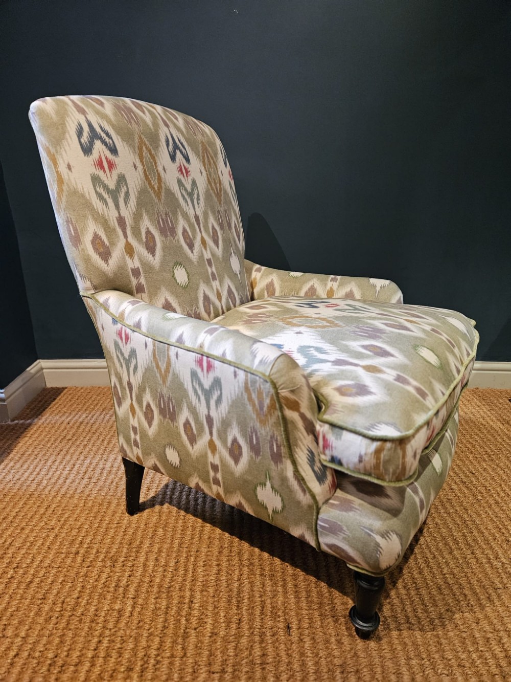 A pair of Victorian armchairs reupholstered in a geometric sage green ikat linen fabric with turned dark timber front legs. View III