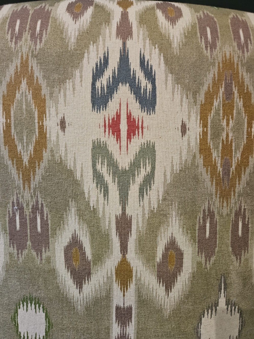 A pair of Victorian armchairs reupholstered in a geometric sage green ikat linen fabric with turned dark timber front legs. View V