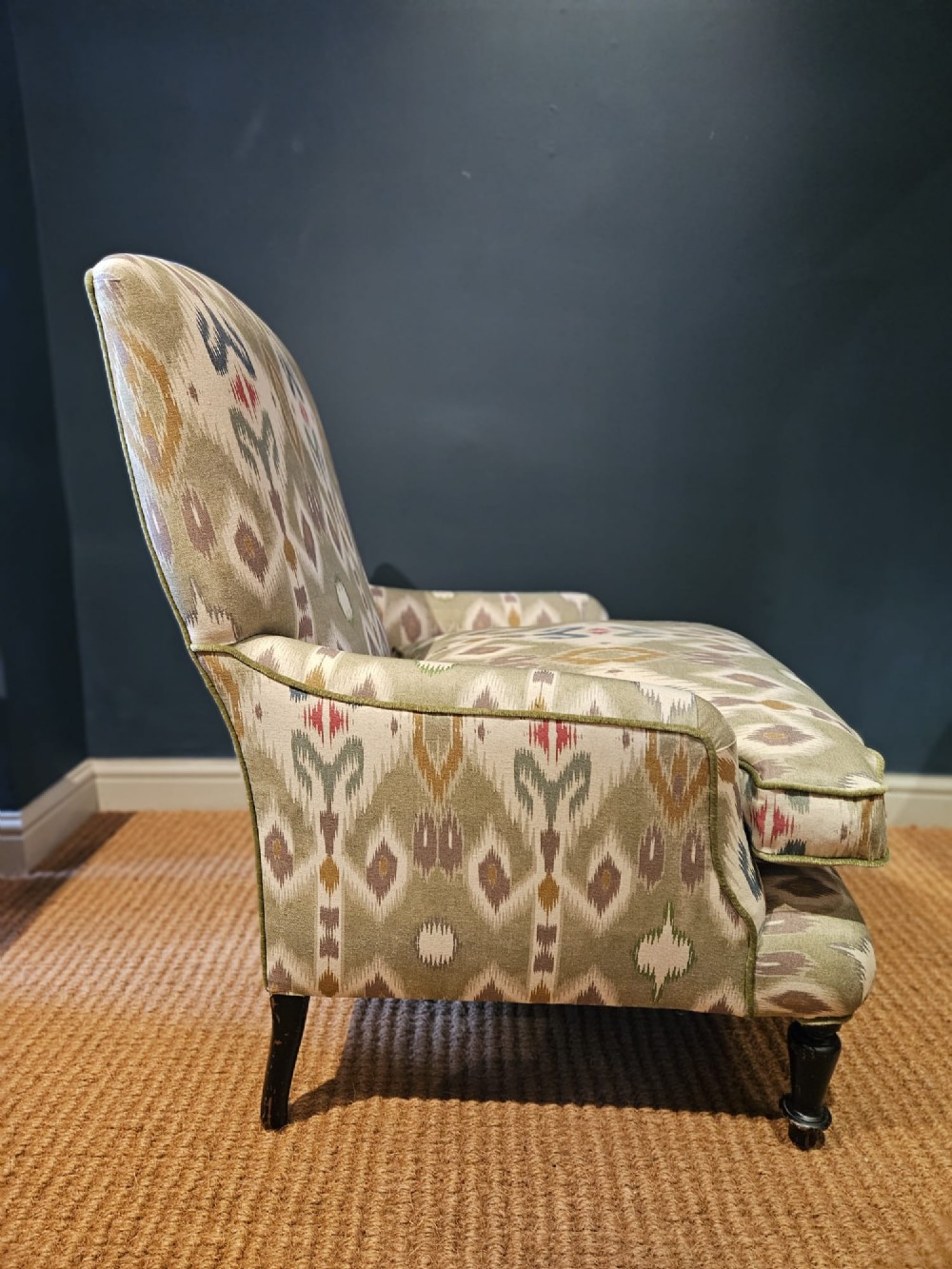 A pair of Victorian armchairs reupholstered in a geometric sage green ikat linen fabric with turned dark timber front legs. View VI