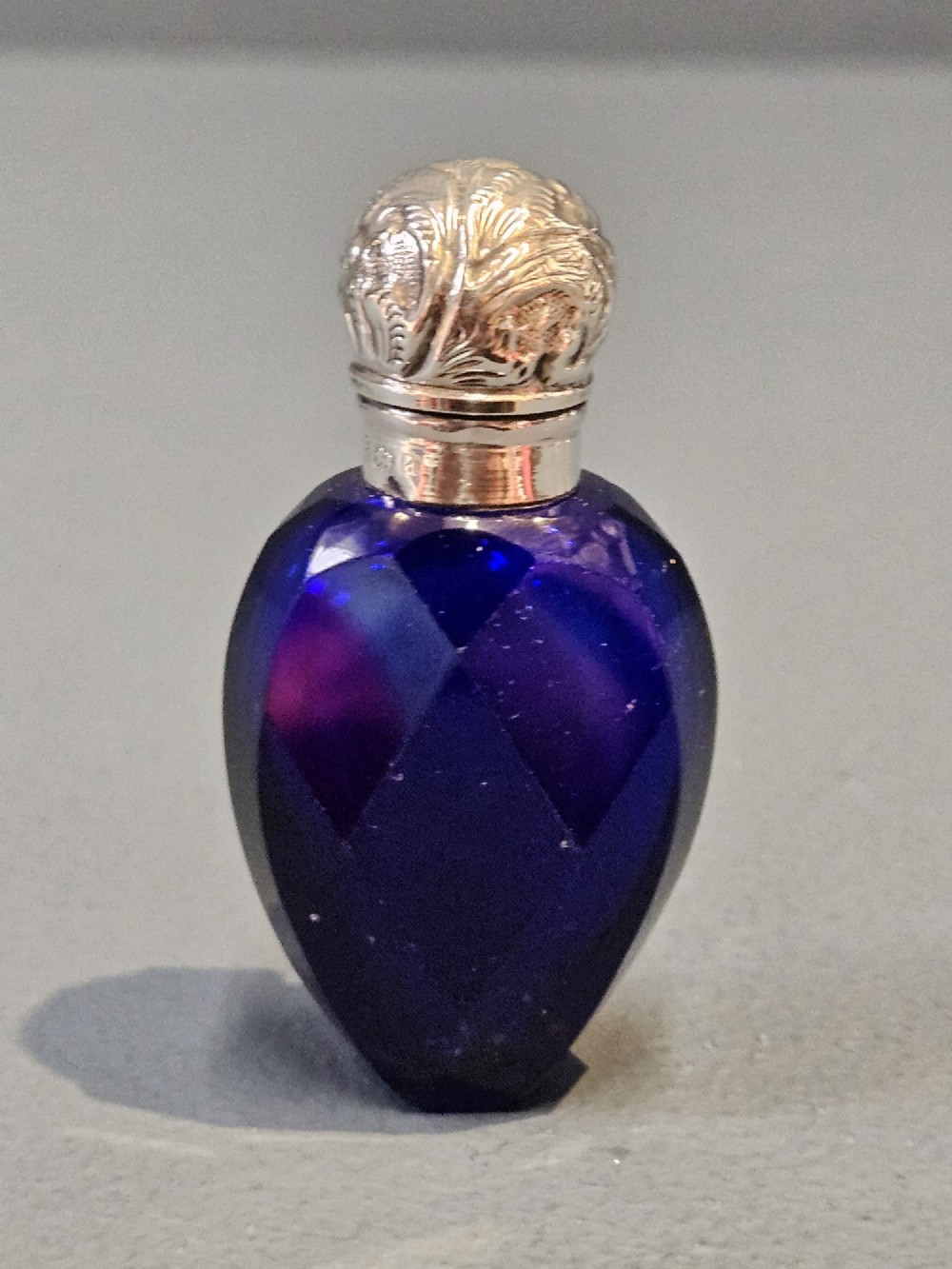 A Victorian faceted cobalt blue glass scent bottle with an engraved sterling silver cap. View III