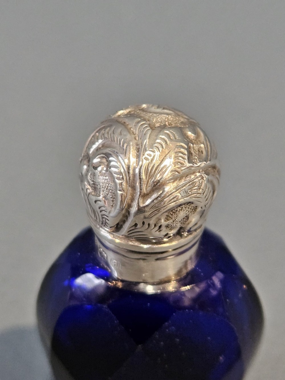 A Victorian faceted cobalt blue glass scent bottle with an engraved sterling silver cap. View IV